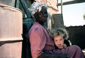 Namibia. Black Kavango woman with her white grandchild.